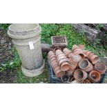 An old drain and chimney pot and a quantity of terracotta plant pots etc.