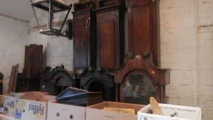 A large quantity of long case clock cases and movements.