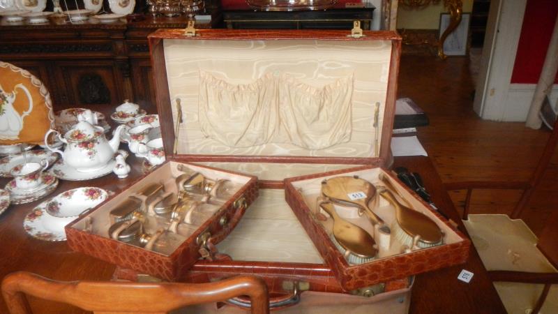 An early 20th century ladies vanity case complete with silver accessories