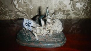 A cast iron figure of 2 hares.
