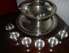 A punch bowl and cups.