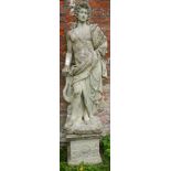 A large stone statue on plinth of a Roman style figure