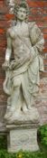 A large stone statue on plinth of a Roman style figure