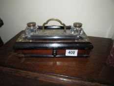 A Victorian ink stand with glass inkwells.