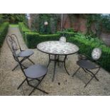 A tile topped garden table and four chairs