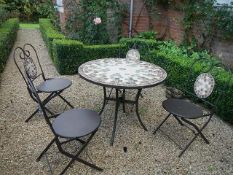 A tile topped garden table and four chairs