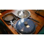 A Le Creuset casserole dish, a frying pan with lid, a grill plate and a small frying pan.