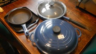 A Le Creuset casserole dish, a frying pan with lid, a grill plate and a small frying pan.