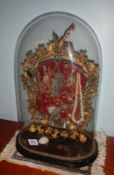 A Victorain decorative centrepiece under glass dome decorated with jewellery etc.