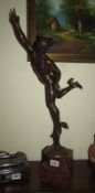 A bronze figure of Mercury on a marble base. a/f, repair to arm.