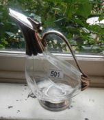 A duck shaped decanter with plated spout.