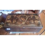 A Victorian inlaid box which wuld have originally housed a music box.