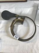 A brass car horn.