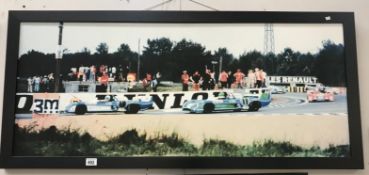 A framed racing scene on canvas.