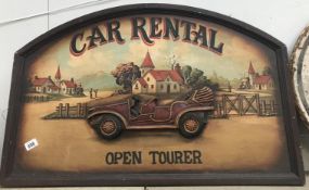A large vintage style car rental sign.