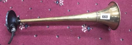 A vintage brass air horn.