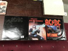 AC/DC 'Back in Black' LP, an AC/DC 12" and Thin Lizzy LP.