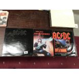 AC/DC 'Back in Black' LP, an AC/DC 12" and Thin Lizzy LP.