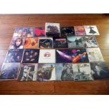Approximately 60 pop and rock vinyl records.