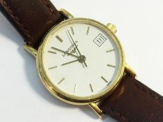 A Longines Ladies Wrist Watch with 18 carat yellow gold face and brown leather strap.