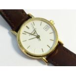 A Longines Ladies Wrist Watch with 18 carat yellow gold face and brown leather strap.