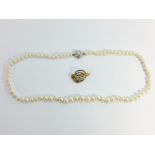 A graduated cultured pearl necklace, measuring 18" in length,