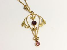 An Openwork Pendant set in 9ct gold with amethyst, garnet and seed pearls.