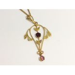 An Openwork Pendant set in 9ct gold with amethyst, garnet and seed pearls.