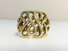 A 9ct gold ring with a scrollwork design. Ring size Q, total weight 6.45 grams.