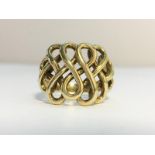 A 9ct gold ring with a scrollwork design. Ring size Q, total weight 6.45 grams.