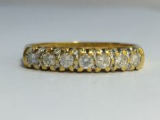 A seven stone Diamond ring in 18ct yellow gold. Diamonds 0.33 ct stamped in band.