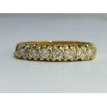 A seven stone Diamond ring in 18ct yellow gold. Diamonds 0.33 ct stamped in band.