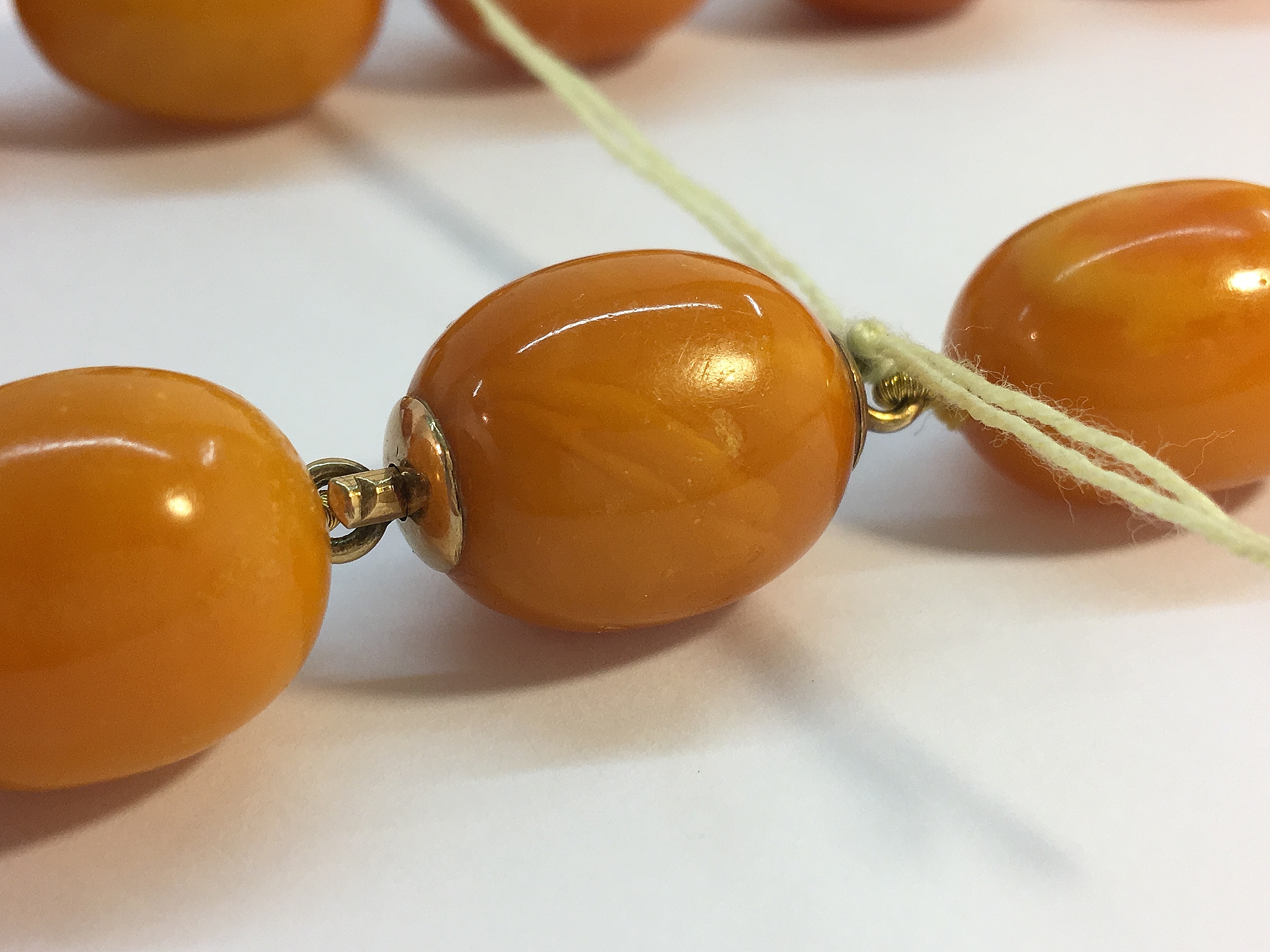 A string of butterscotch amber beads, approximately 18" in length. - Image 3 of 6