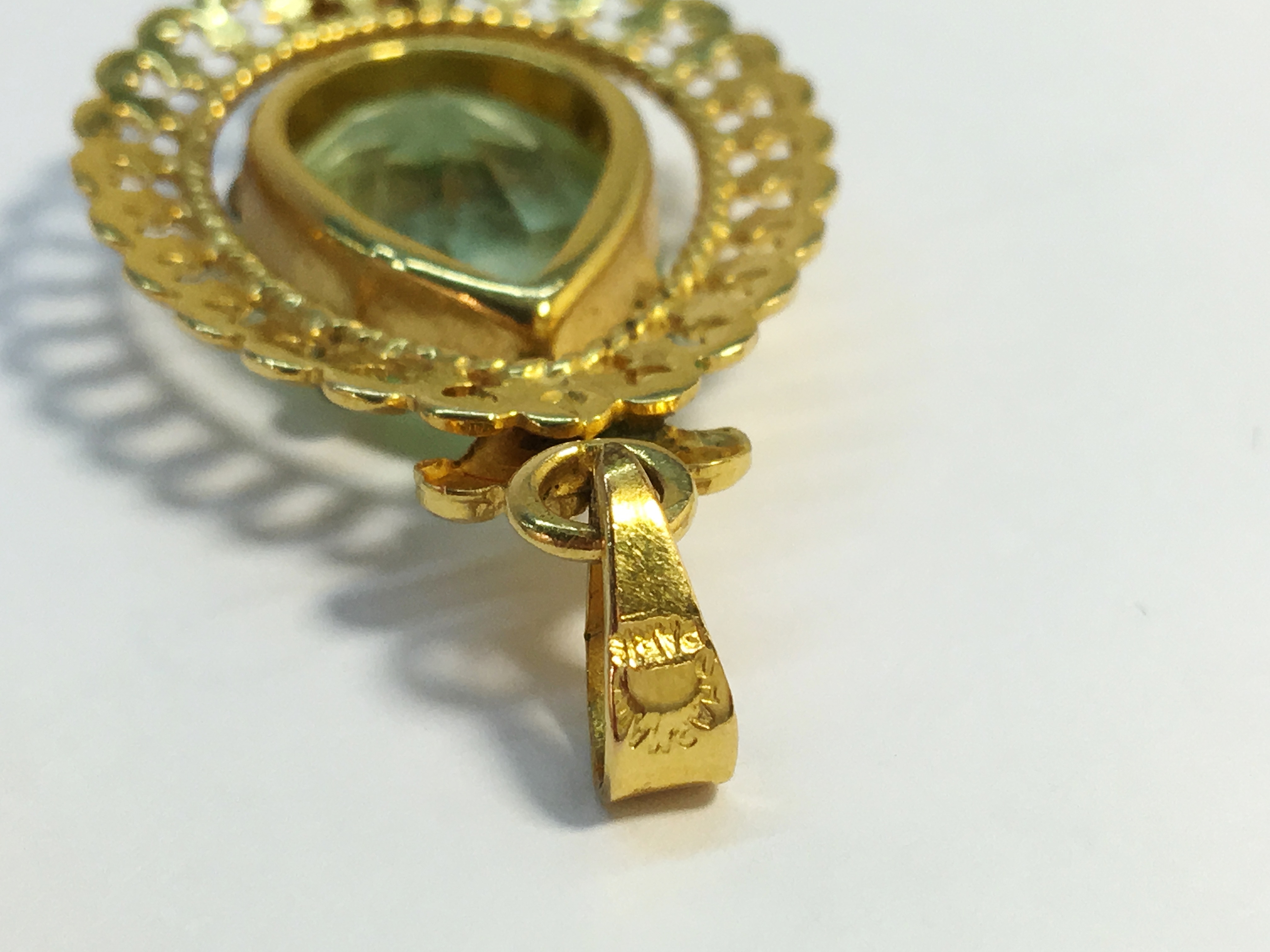 An Art Deco pendant in 9ct gold set with an oval cut blue stone, branded Amerikaner, weight 4. - Image 5 of 6