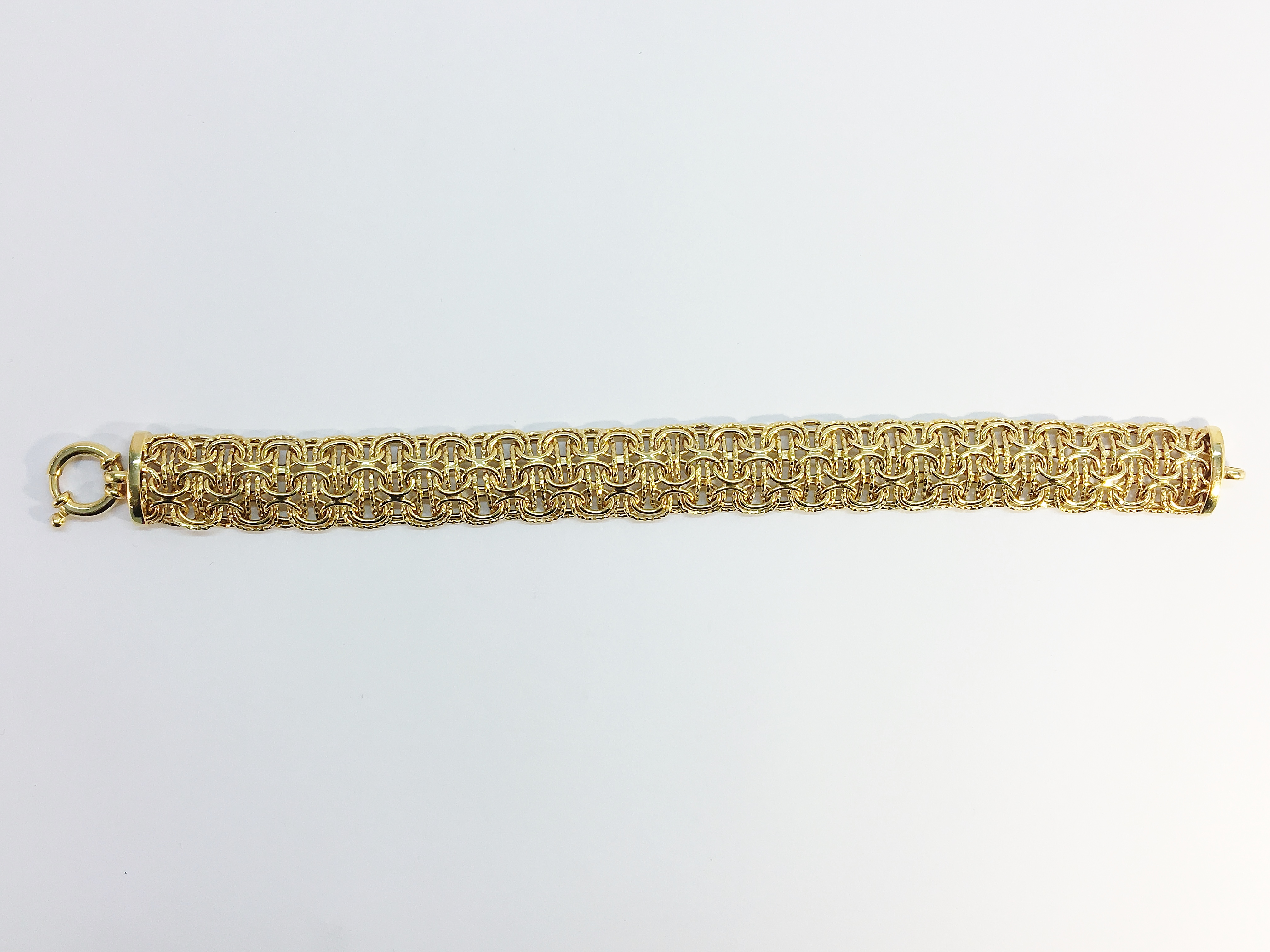 A Contemporary Italian Woven Bracelet by Milros in 14 ct Yellow Gold. With bolt ring clasp closure.