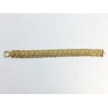 A Contemporary Italian Woven Bracelet by Milros in 14 ct Yellow Gold. With bolt ring clasp closure.