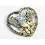 A Georg Jensen silver brooch fashioned as a dove and olive branch within a heart. No 239.