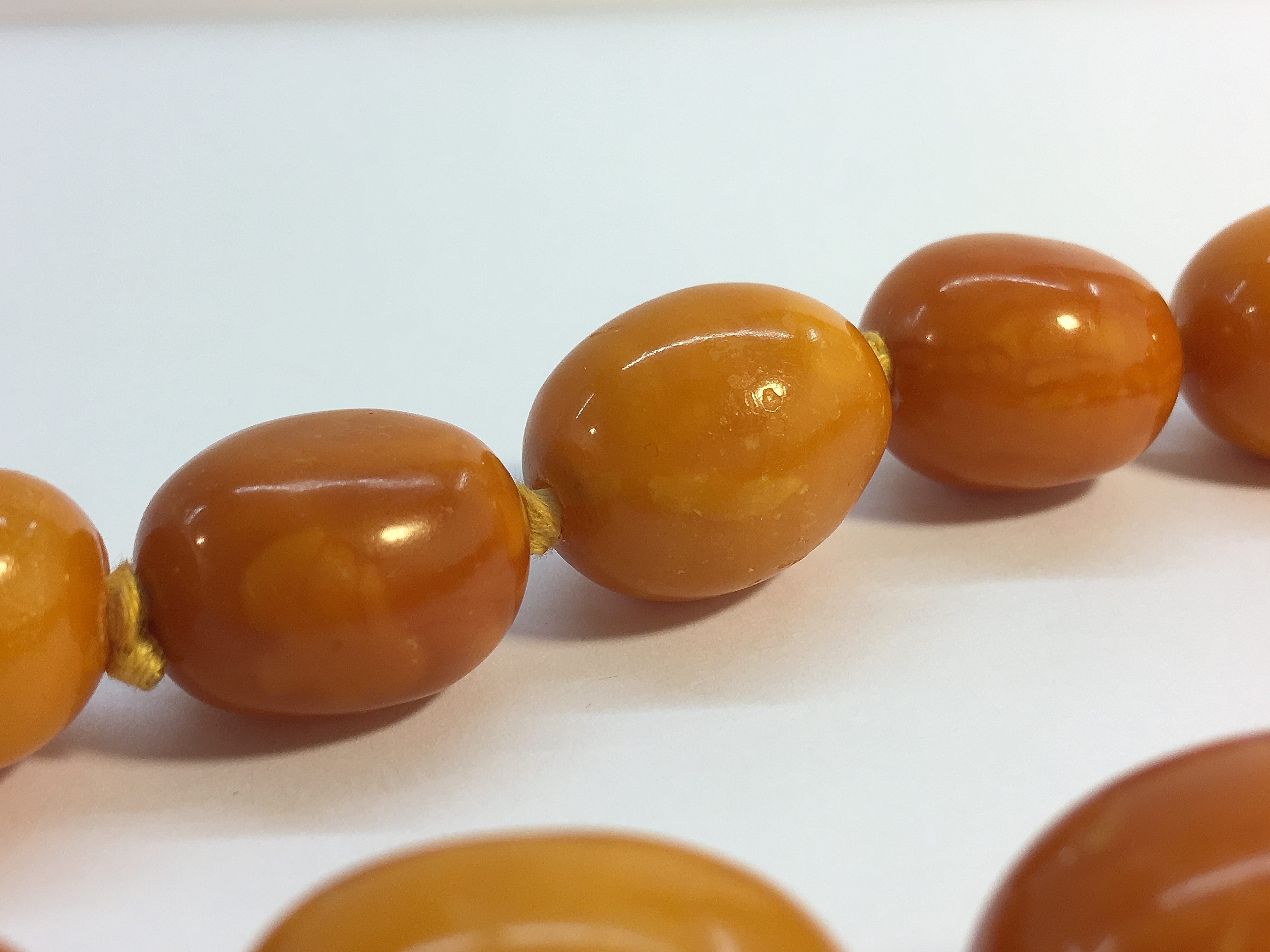 A string of butterscotch amber beads, approximately 18" in length. - Image 5 of 6