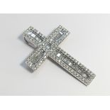 A Diamond Cross set with baguettes and brilliant cut diamonds in 18ct gold.