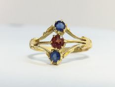 An Antique Sapphire and Garnet Three Stone Ring in ornate 18ct yellow gold shank.