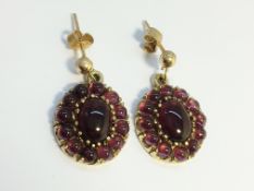 A Pair of Carbuncle Garnet earrings in 9ct yellow gold,