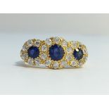 A Victorian Diamond and Sapphire three stone ring in 18ct yellow gold ornate shank.