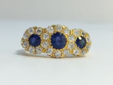 A Victorian Diamond and Sapphire three stone ring in 18ct yellow gold ornate shank.