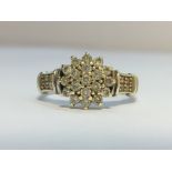 A Diamond Floral Cluster ring in 9ct white gold. Diamonds 0.50 ct stamped in band.