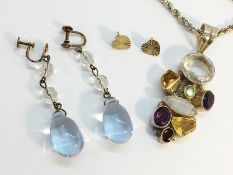 A Chunky gemstone pendant set in silver with Peridot, amethyst, citrine, garnet,