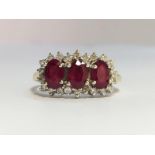 A Ruby and Diamond Trilogy Ring in 18ct yellow gold. The oval shape rubies have an ETCW of 0.