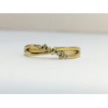 A Double band Diamond Crossover ring in 9ct yellow gold. Diamonds ETCW 0.05 ct.