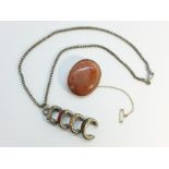 An Antique oval Scottish Agate brooch, in 9ct rose gold with safety chain attached.