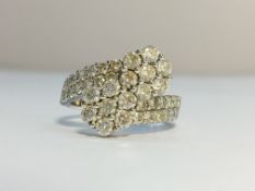 A Diamond Ring set in 18ct white gold, fashioned as crossing flowers. ETCW 1.