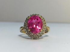 A Pink Sapphire and Diamond Cluster Ring in 9ct yellow gold. Diamonds ETCW 0.44 ct, sapphire ECW 3.